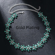 Trendy women's rhinestone clavicle chain necklace in green, featuring flower design with gold plating.