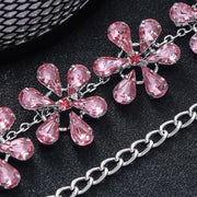 Trendy rhinestone clavicle chain necklace for women featuring pink flower-shaped pendants and a silver-plated design.